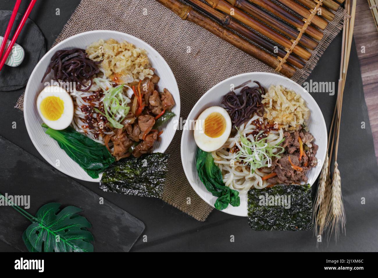 A top view of two portions of nutritious Japanese ramen in a restaurant