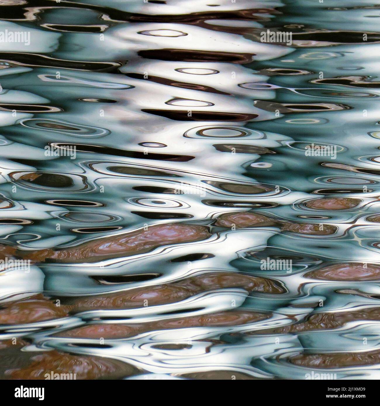 British waterway abstract photograph showing reflected pattern, texture, shape, and movement, with a colour pallette showing in light forms mirrored r Stock Photo