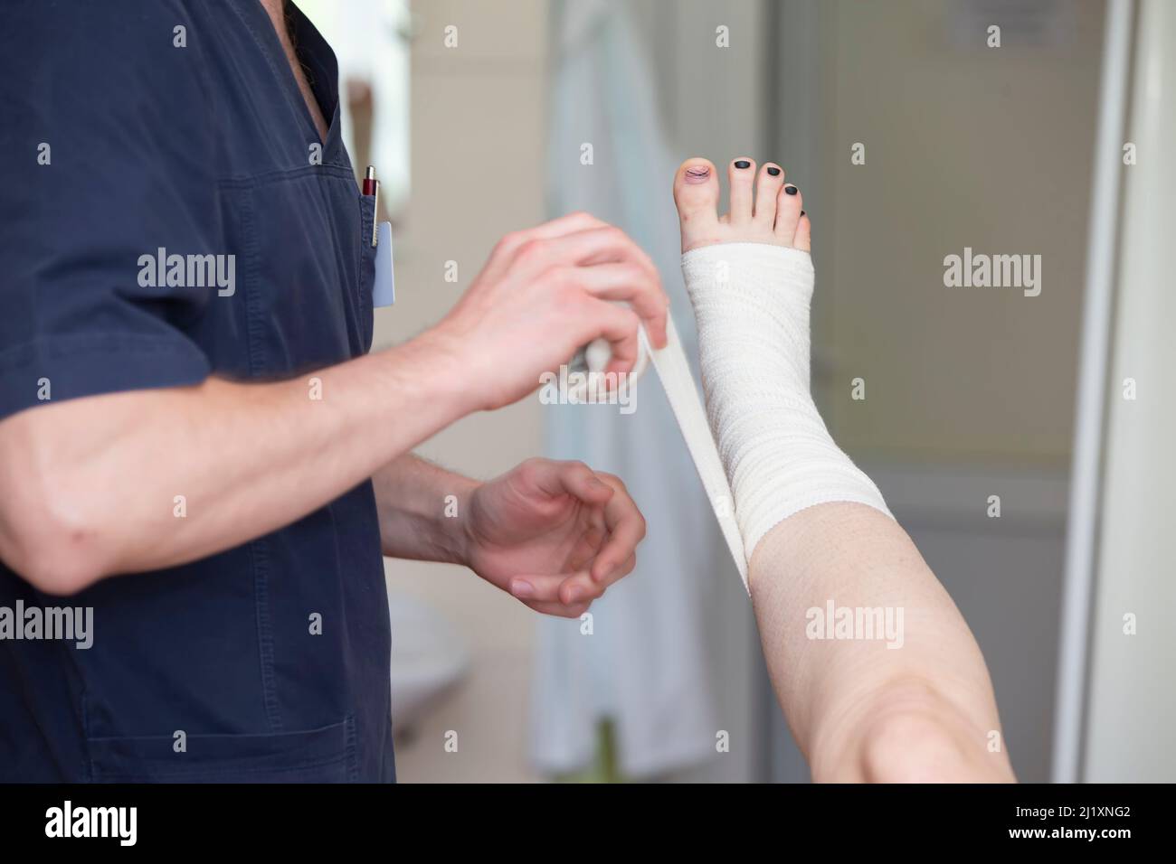 The doctor bandages the patient's leg. Surgeon and patient after vein surgery Stock Photo Alamy