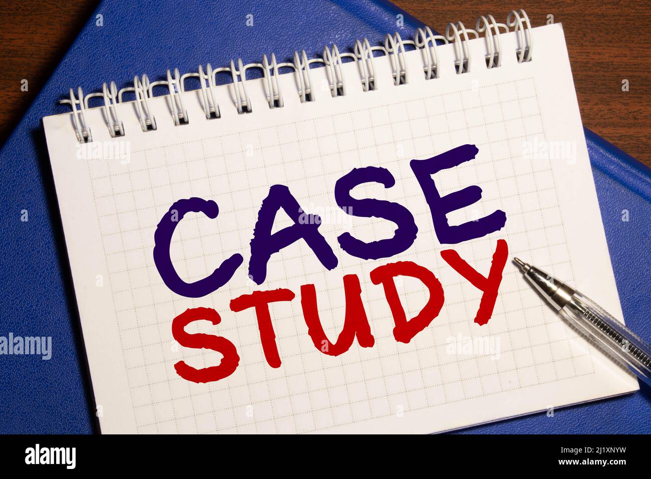Case study memo written on a notebook with pen. Stock Photo