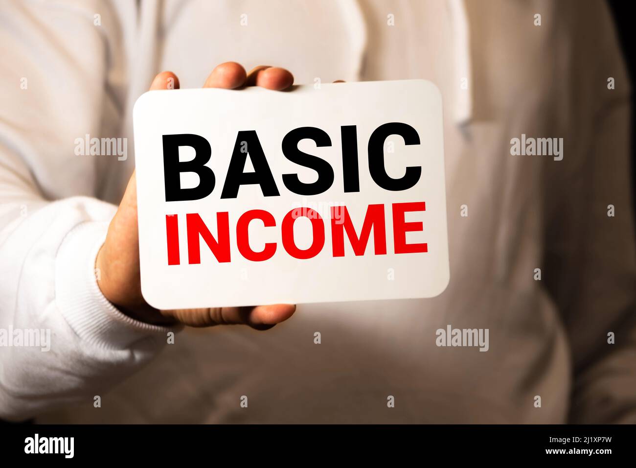 Basic income word with blurring business background Stock Photo - Alamy