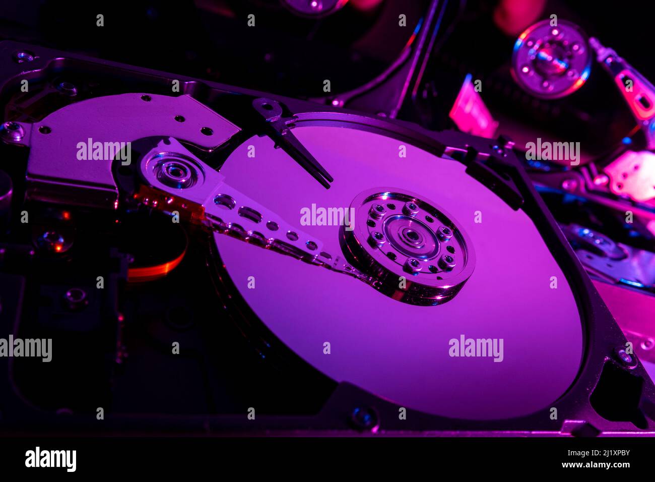 Close up of the open case of a computer hard drive showing the disc and