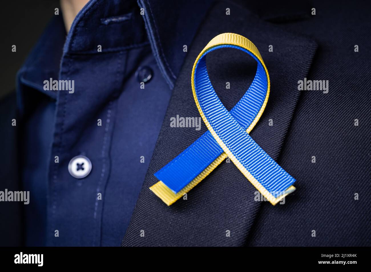 Blue and yellow ribbon for Ukraine on the suit lapel Stock Photo