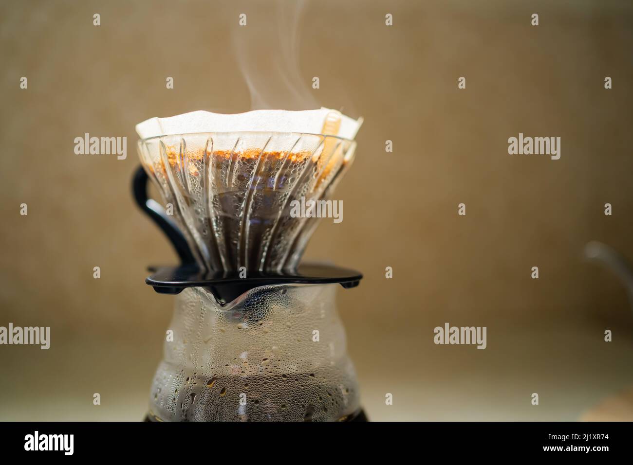 Coffee dripper and carafe with steam Stock Photo