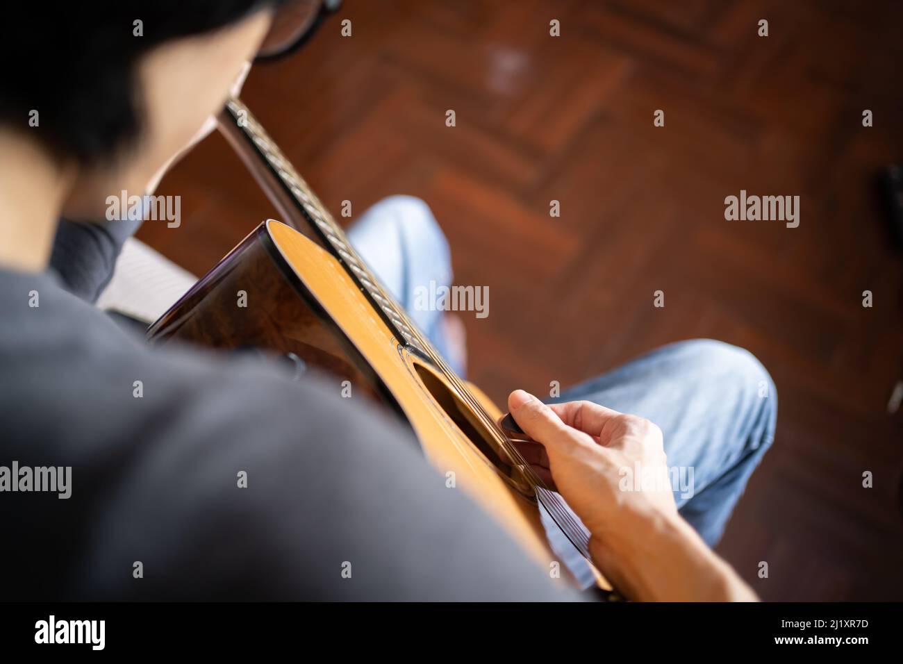 A man playing acoustic guitar Stock Photo