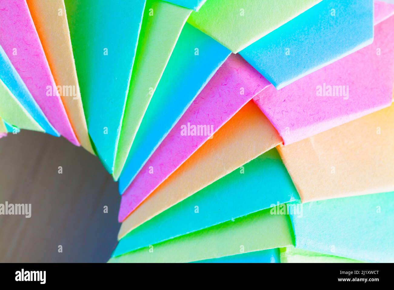 Origami ring, fragment of an abstract parametric structure made of colorful paper sheets. Close up photo with selective soft focus Stock Photo