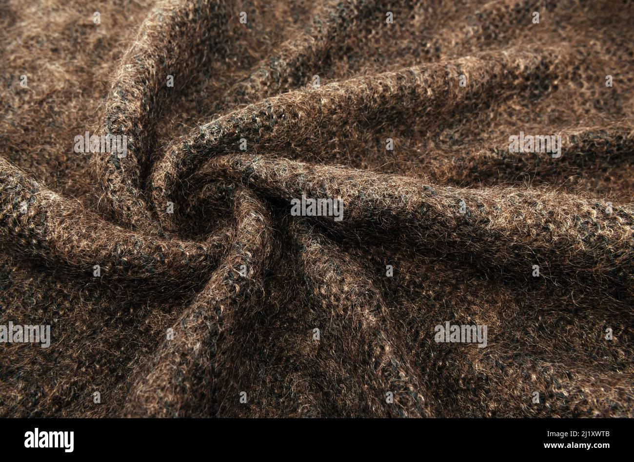 Twisted brown lambswool fabric with waves and curves. Wool material. felt texture Stock Photo