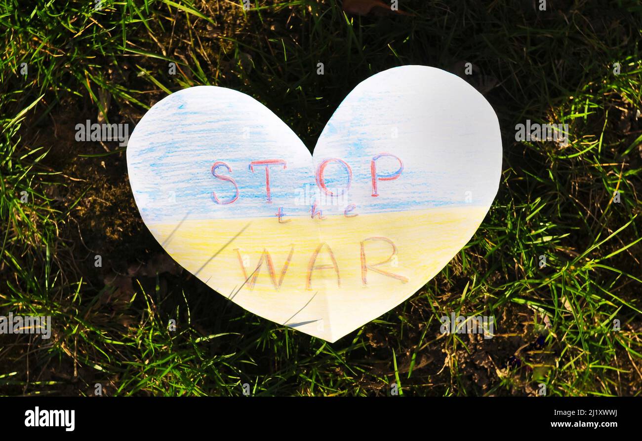 Ukrainian flag from paper heart shape with losung stop the war. High quality photo Stock Photo