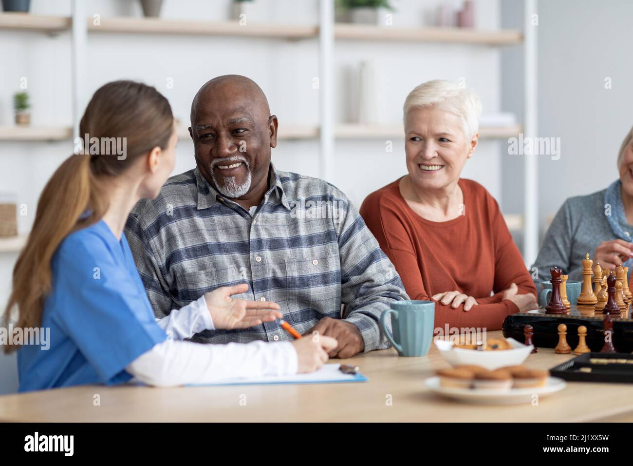 Nurse having conversation with african american senior man Stock Photo