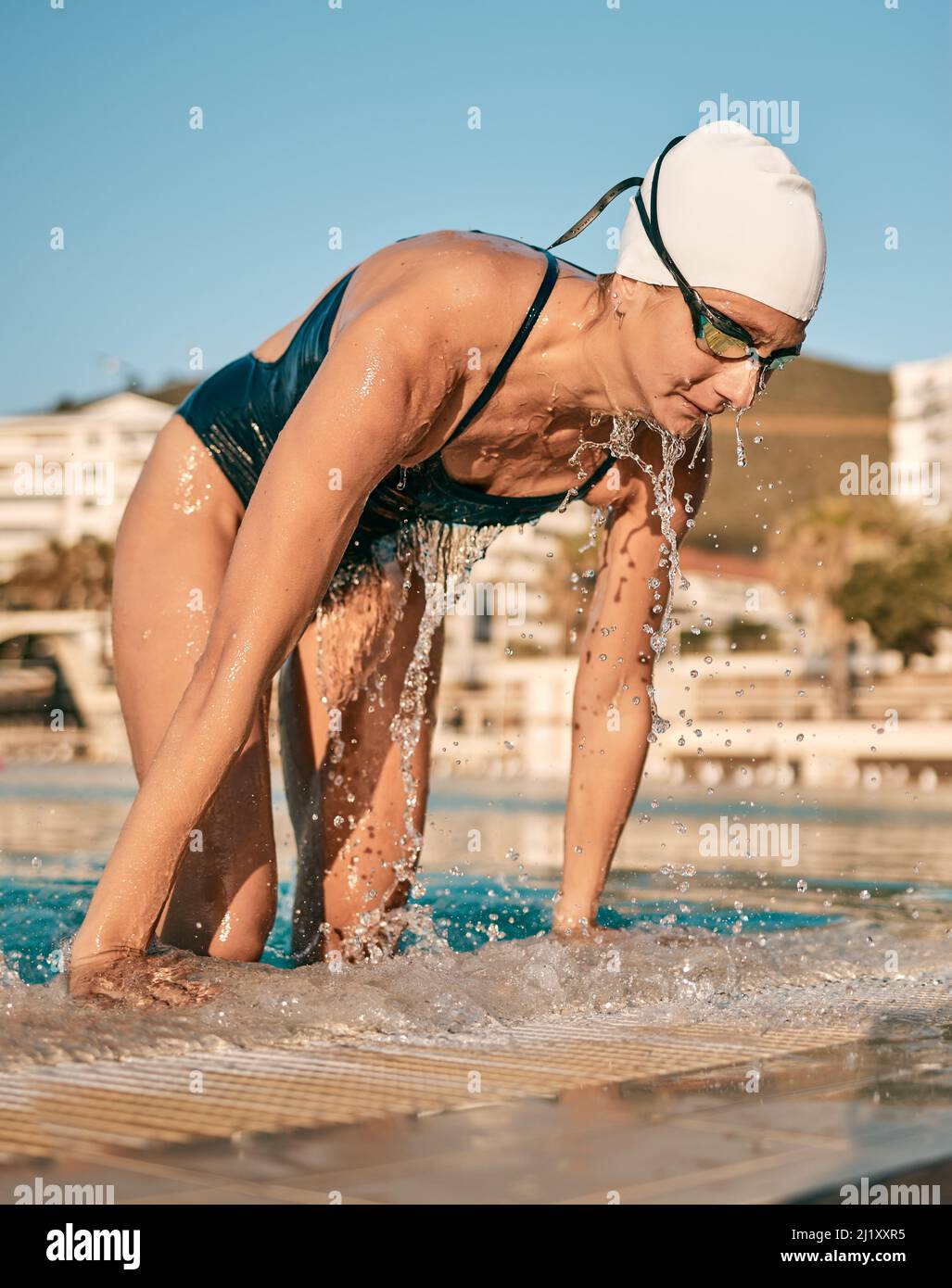 Man is taking pictures of young beautiful smiling wet woman in