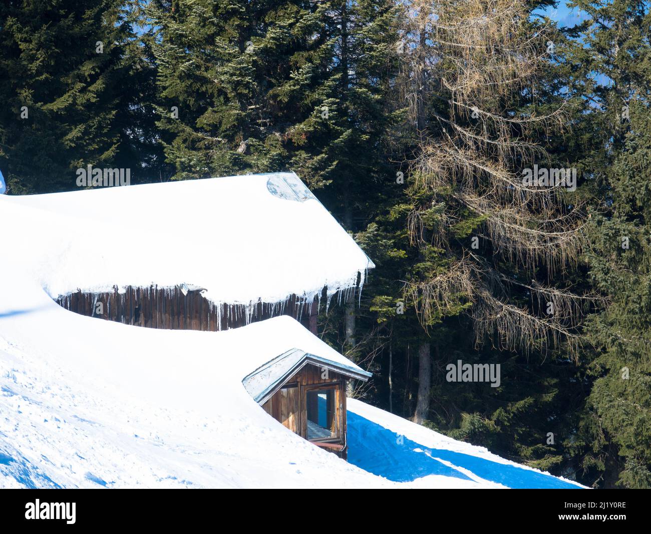 Winter house covered with layers of snow. Old, impressive, snow-covered ski lodge in the austrian alps Stock Photo