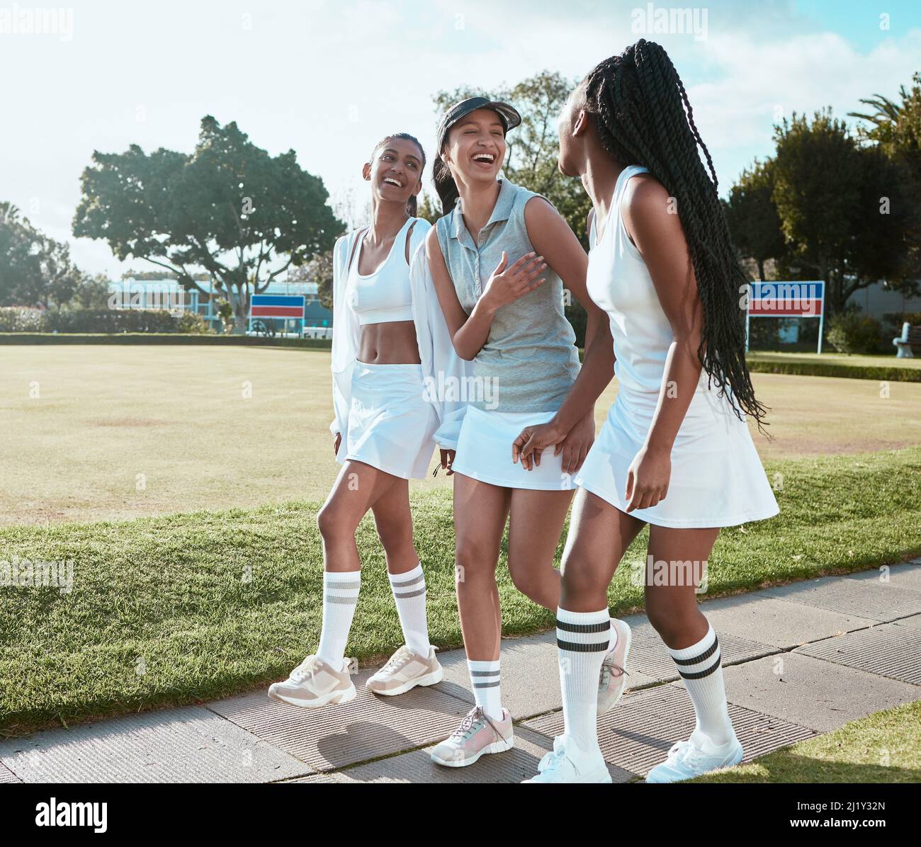 Happiness is a game of tennis away. Shot of three young women out playing tennis. Stock Photo