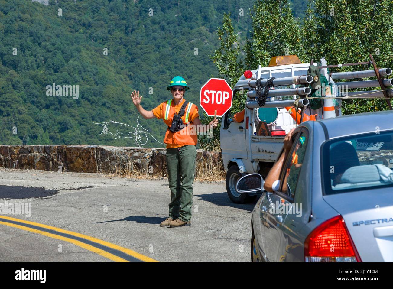 Sequoia Park, USA - July 21, 2008: woman stops car at the construction site of a winding road in the national park. Stock Photo