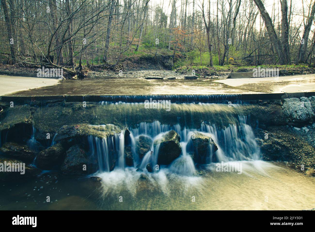 A beautiful landscape of a water cascade in a forest Stock Photo - Alamy