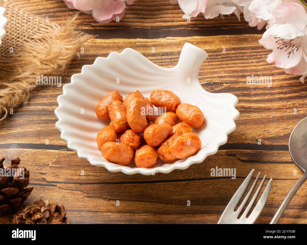 Fried small bean in dish side view on wooden table taiwan style food Stock Photo