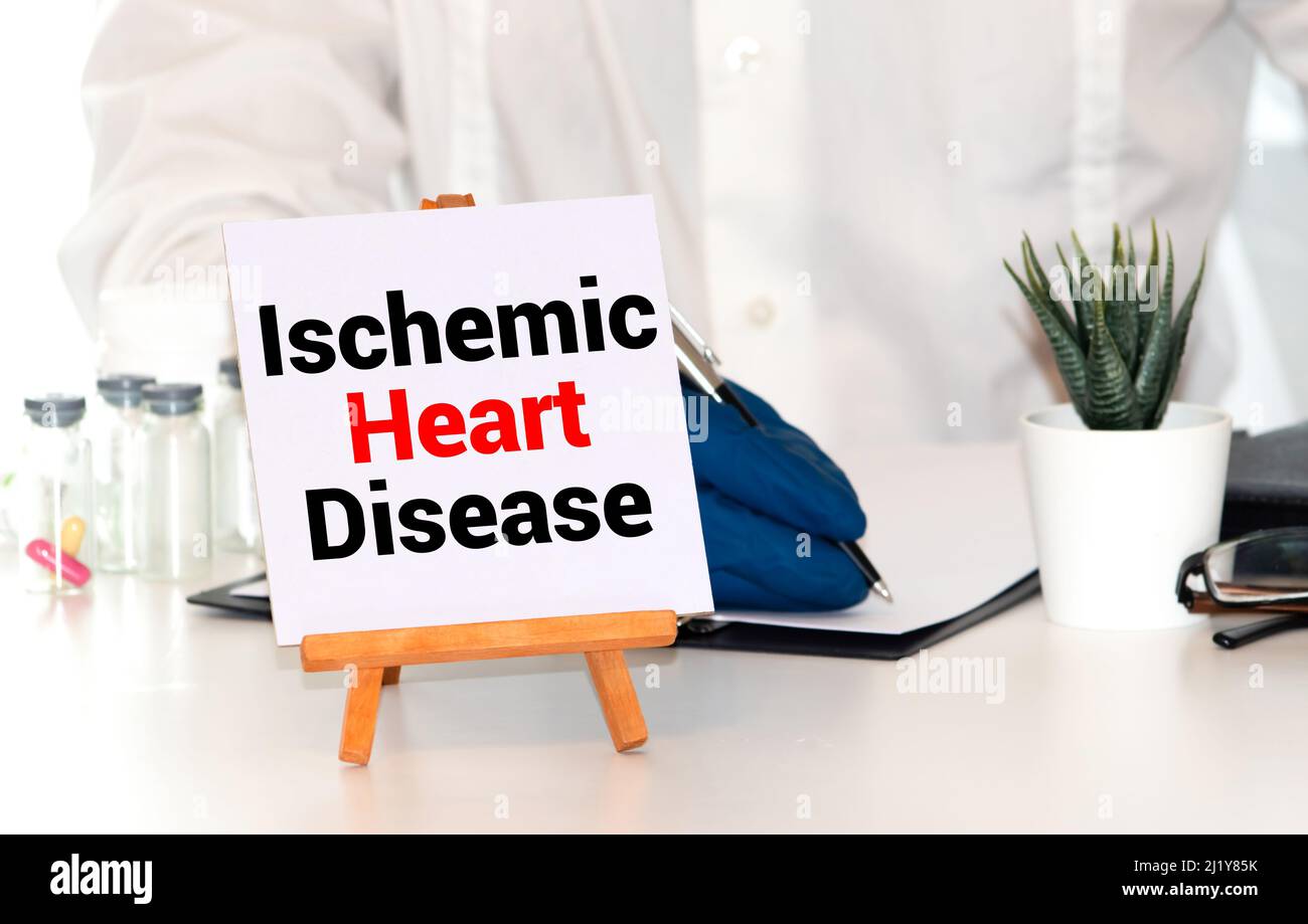 Ischemic Heart Disease written on notebook with stethoscope, syringe and pills. Medical concept. Stock Photo