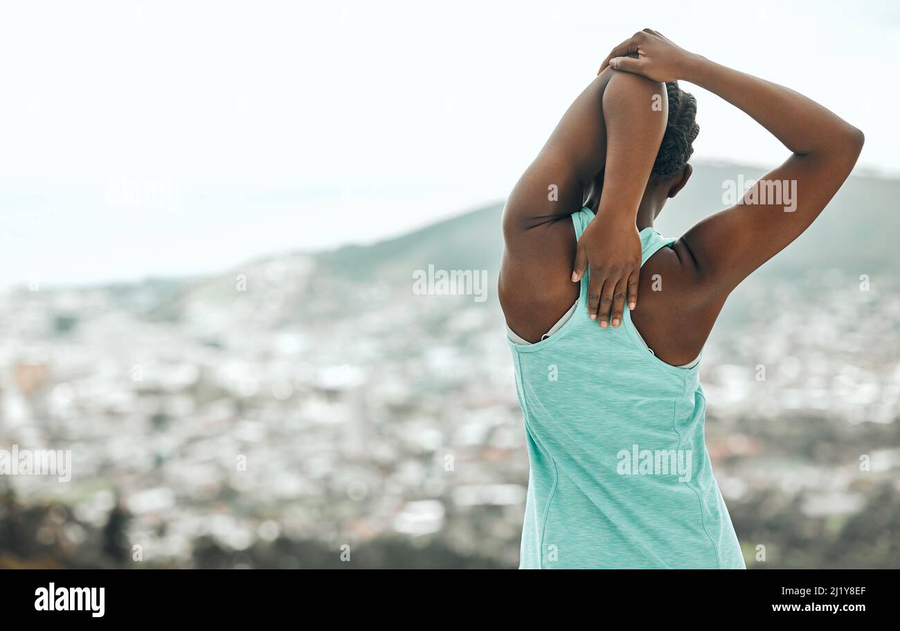 Stretching the stress away. Shot of an unrecognizable person stretching before a run. Stock Photo