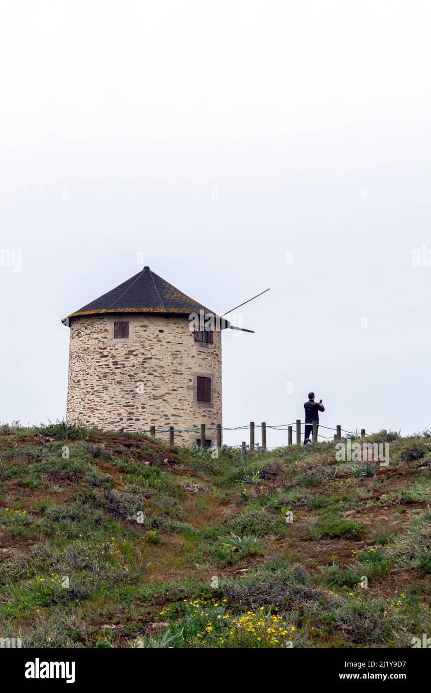 Hiking in Portugal on northwest coast in Apúlia beach near to windmills, tourism accommodation on windmills. Windmills near the ocean. Walking in Portugal. Stock Photo