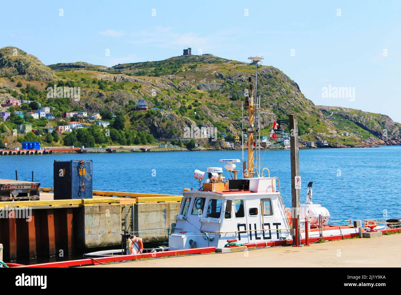 Pilot boat docked at a pier, St. John's Harbour. Signal Hill and Cabot Tower in background. Stock Photo