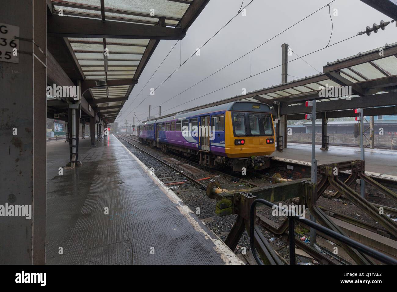 Northern rail class 142 pacer train 142035 at Preston  railway station south bay with the buffer stops made from old rails with red tail lights Stock Photo