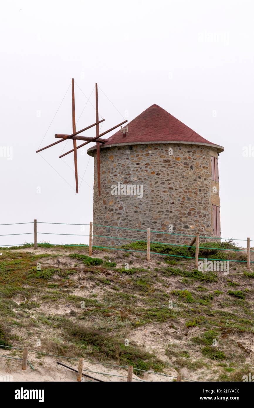 Hiking in Portugal on northwest coast in Apúlia beach near to windmills, tourism accommodation on windmills. Windmills near the ocean. Walking in Portugal. Stock Photo
