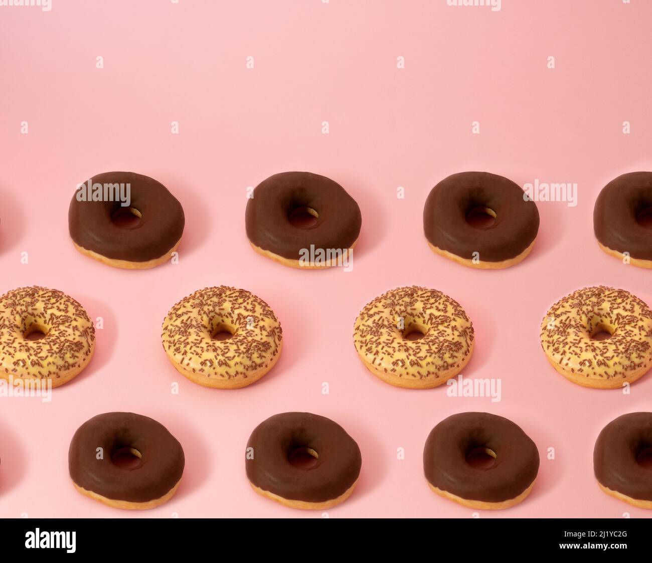 Chocolate and vanilla donuts party pattern on minimal pastel pink ...