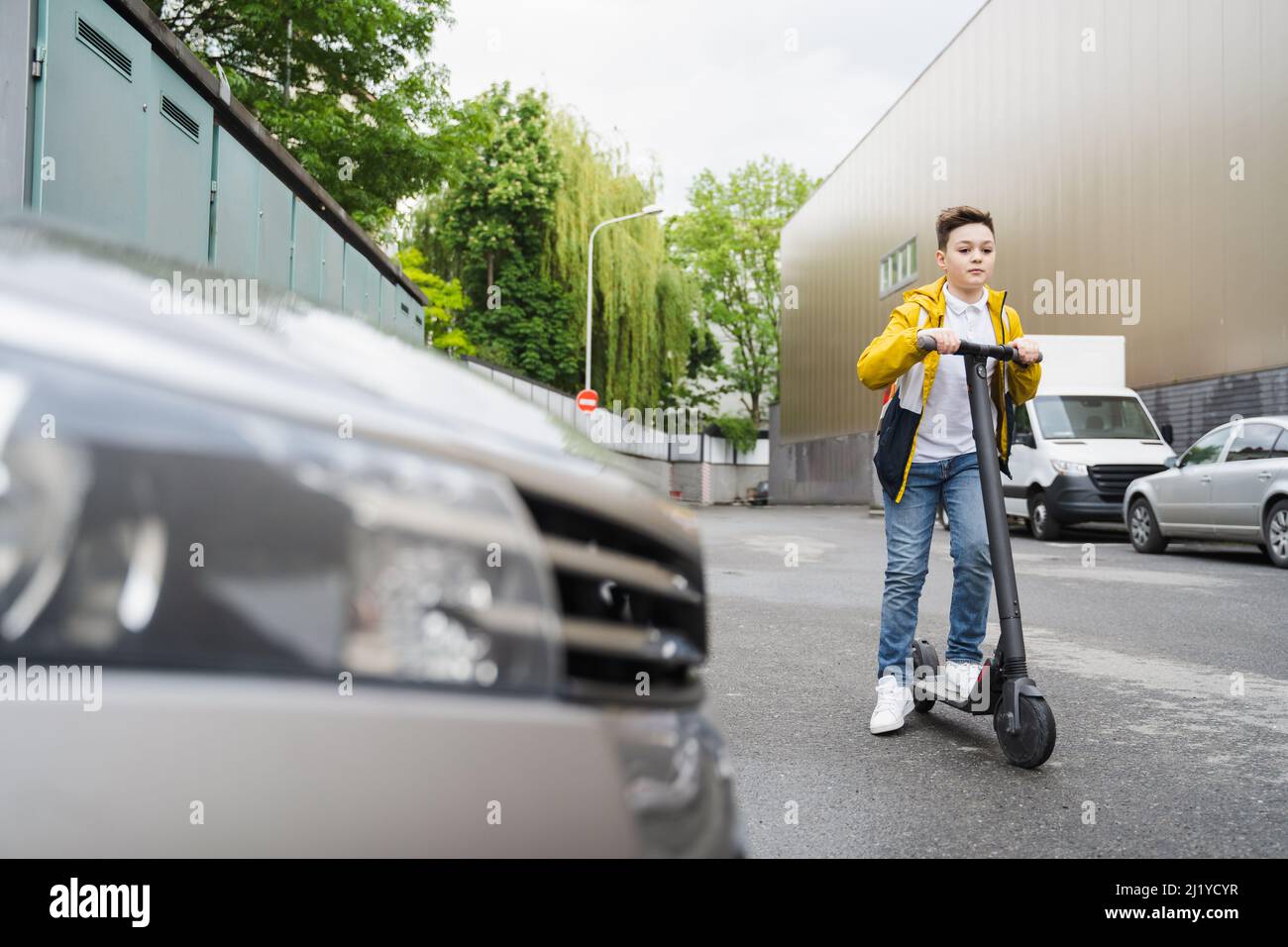 Boy riding electric scooter hi-res stock photography and images - Alamy