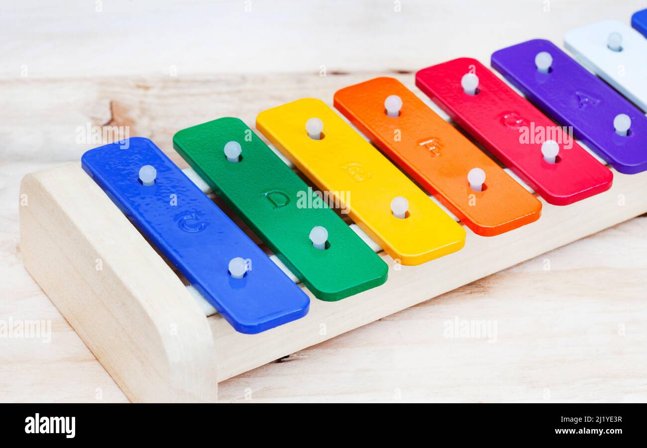 Colorful kids’ xylophone with note scale lettering on plain background