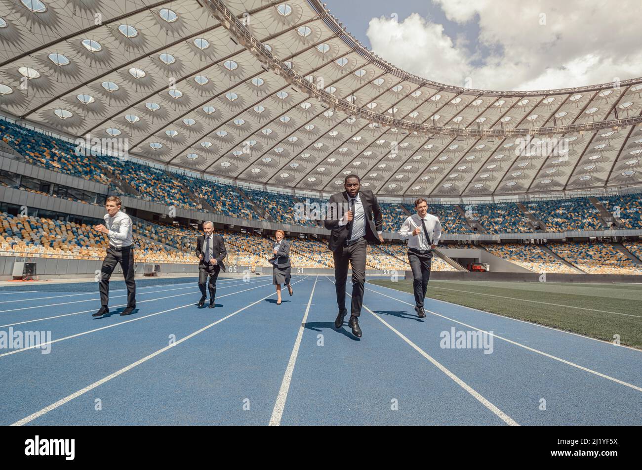 People in business suits running on modern sports track Stock Photo