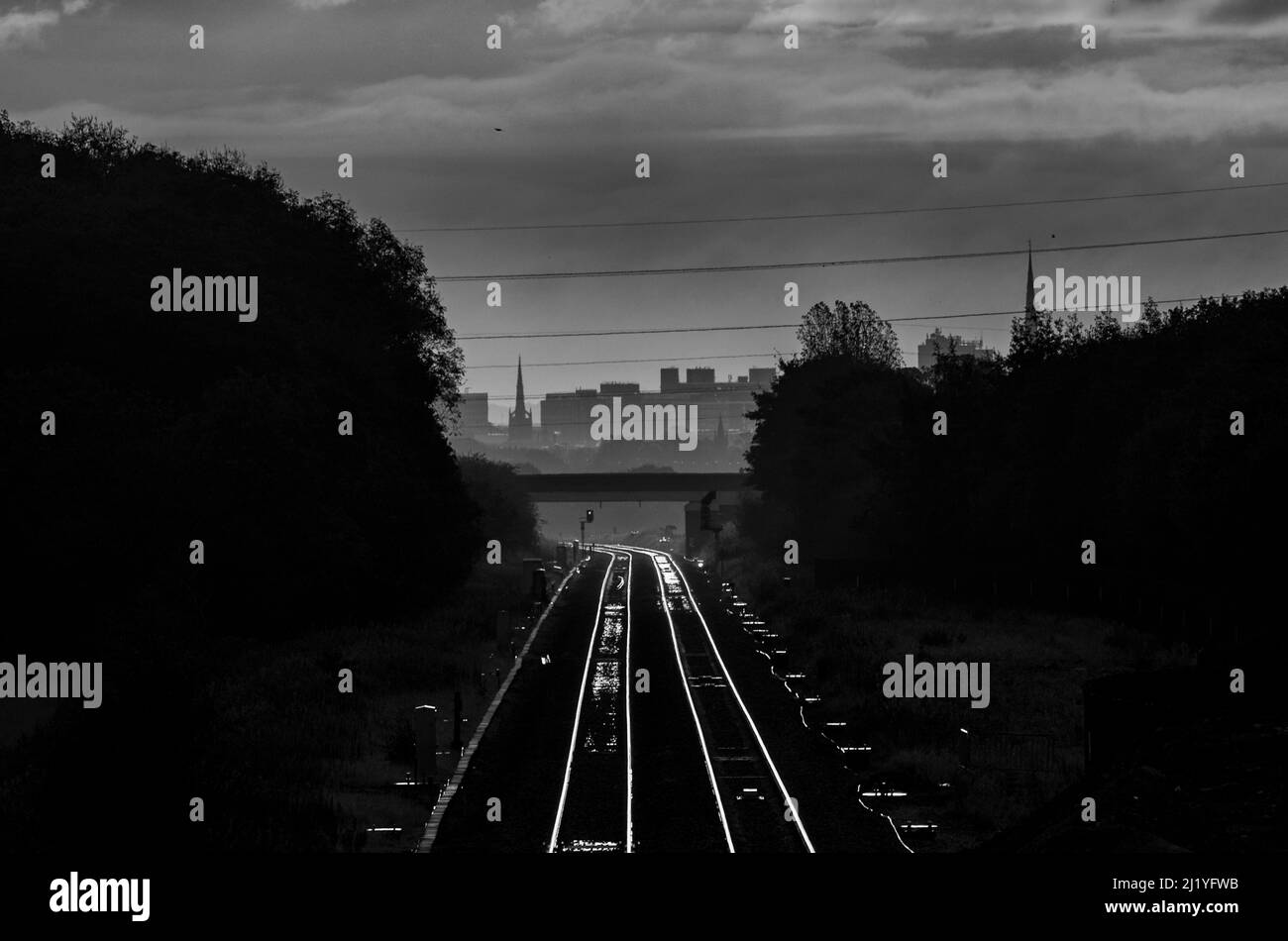 Low early morning winter sunlight glinting off the two track railway at
