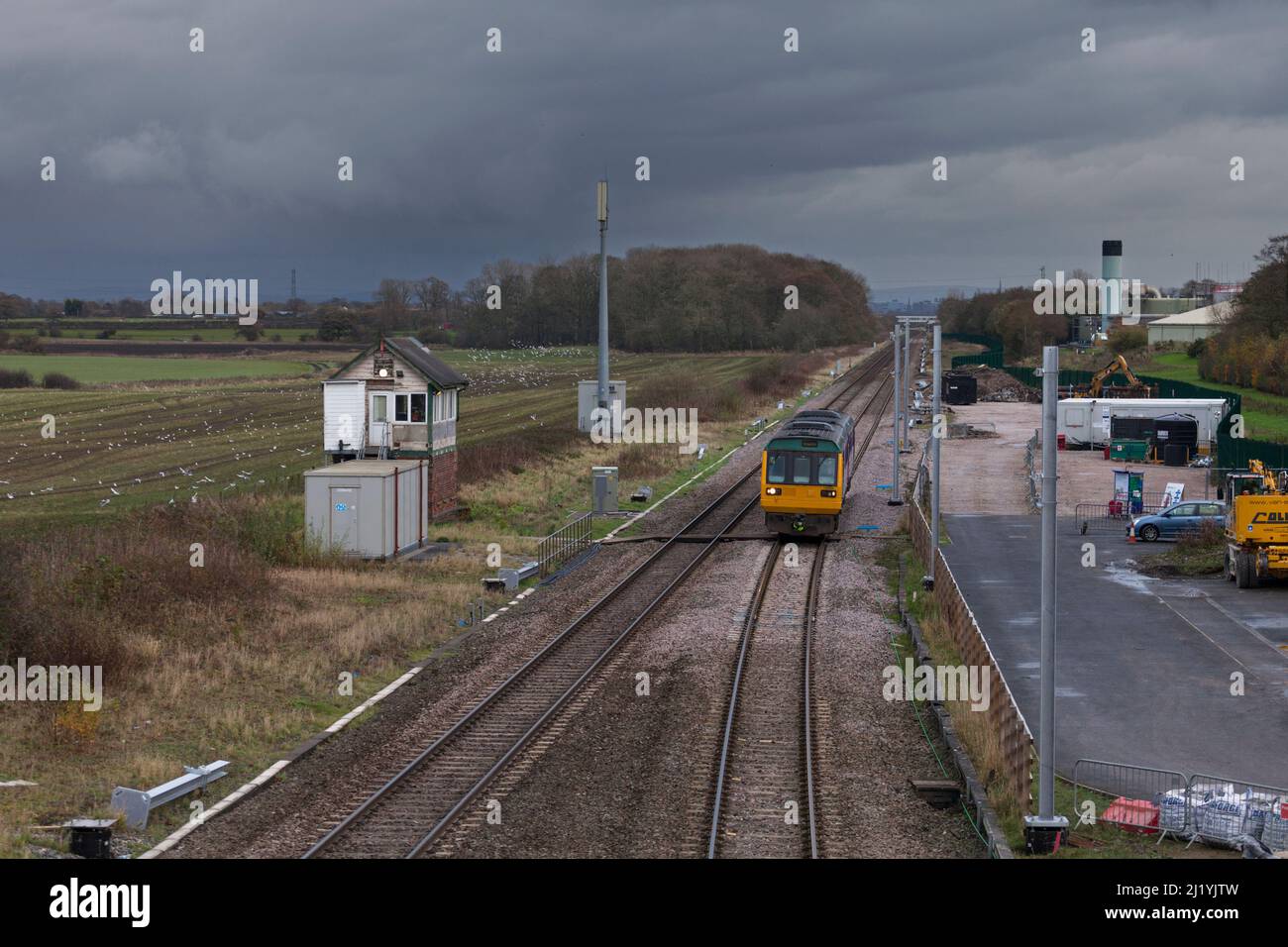 Northern Rail class 142 pacer trains passing the Lancashire and Yorkshire railway mechanical signal box at Salwick on the day it closed. Stock Photo