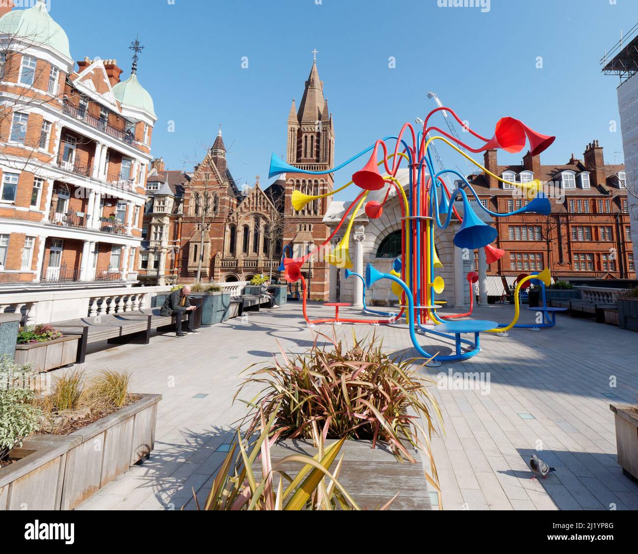 Brown Hart Gardens, a raised public garden off Duke Street. Colourful Sonic Bloom exhibition and the Ukranian Catholic Cathedral behind.London. Stock Photo