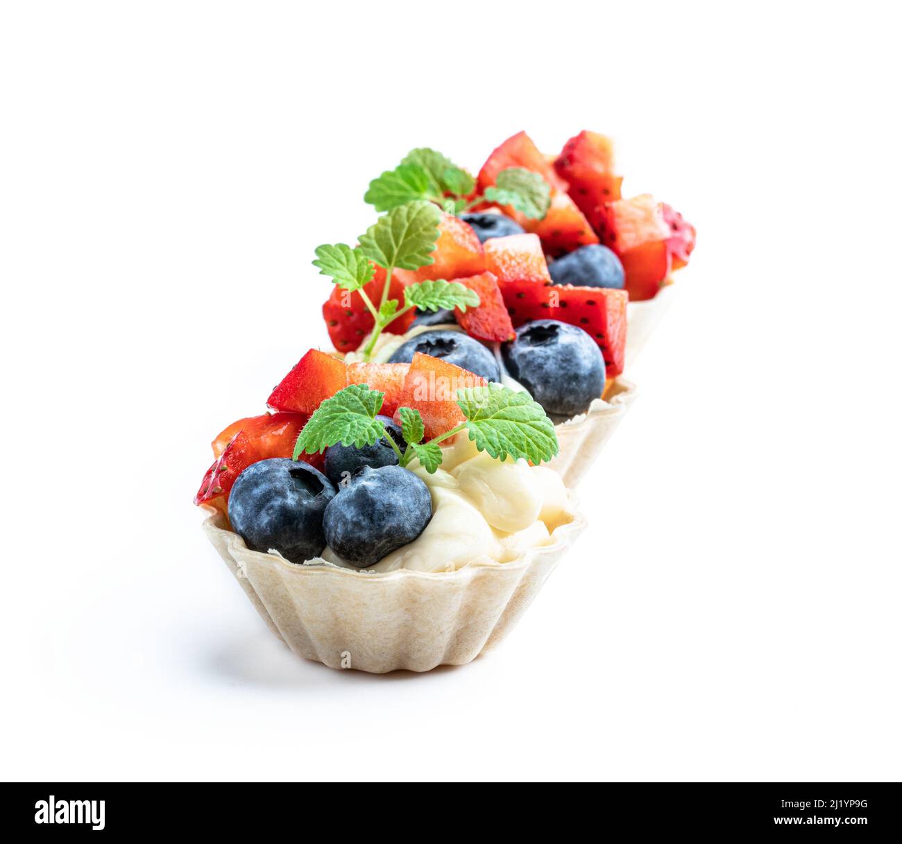 Fresh  berry tartlets dessert isolated on white Stock Photo