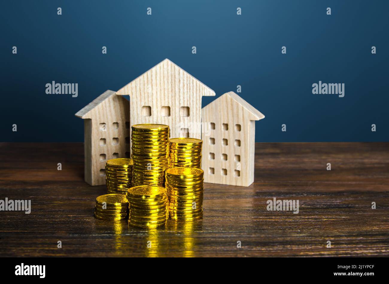 Residential buildings and coins stacks. Business and real estate. Rental income. Capitalization and value of assets. Property valuation. Budget. Tax c Stock Photo