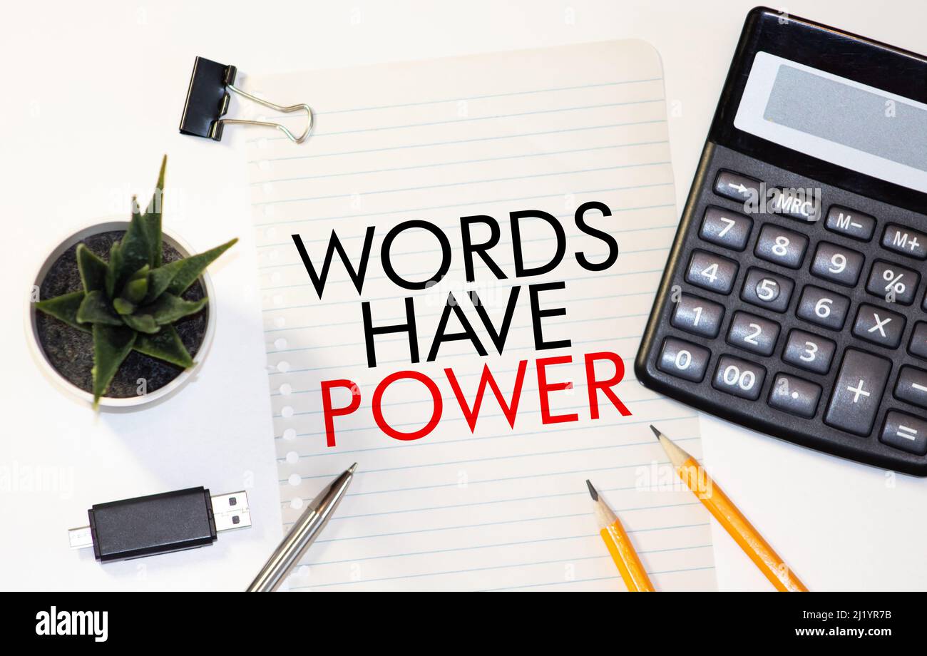 The phrase Words Have Power printed on a scrap of lined paper and taped to a red notice board Stock Photo