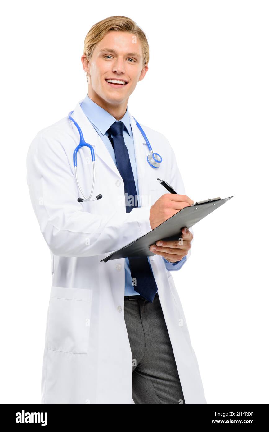 Any other symptoms. Shot of a handsome young doctor standing alone in the studio and writing on a clipboard. Stock Photo