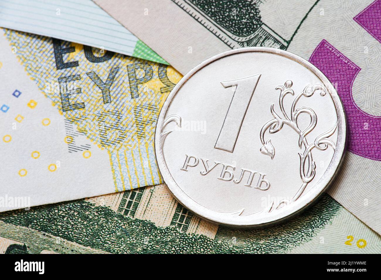 One ruble against the background of euro and dollar banknotes Stock Photo
