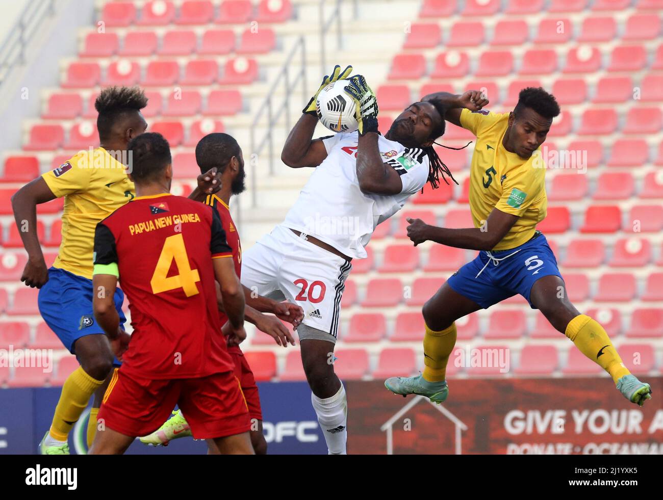 DOHA, QATAR - MARCH 27: Ronald Warisan of Papua New Guinea competes for the  ball with Javin Wae of Solomon Islands ,during the FIFA World Cup Qatar  2022 qualification match between the