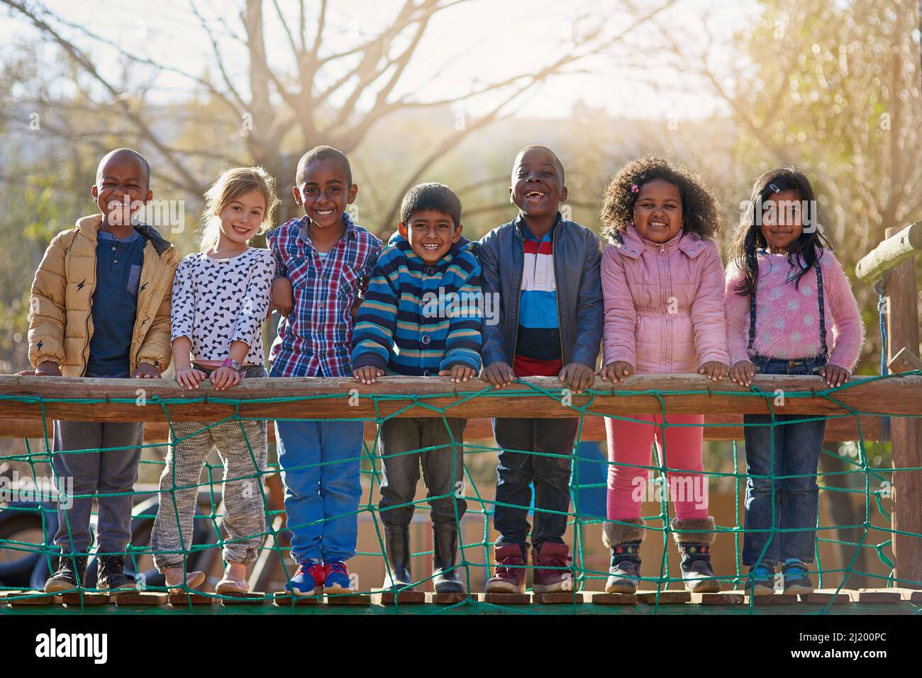The park is our happy place. Portrait of a group of little children ...