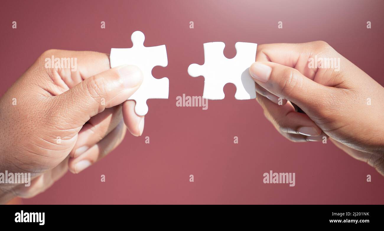 Solving the puzzle, piece by piece. Cropped shot of two unrecognizable ...