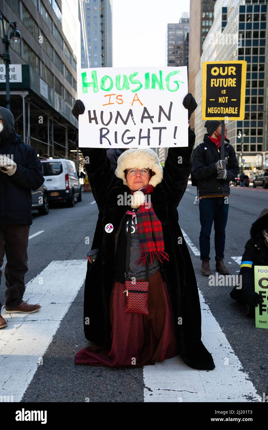 New York, United States. 28th Mar, 2022. Woman holds sign saying