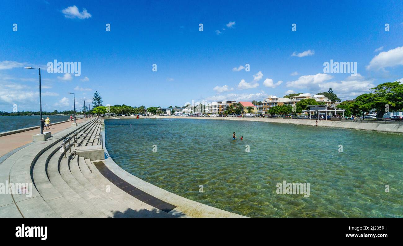 heritage-listed Wynnum Wading Pool is a large oval shape tidal pool measuring 128 by 54 metres at a recreational reserve on the foreshore of Southern Stock Photo