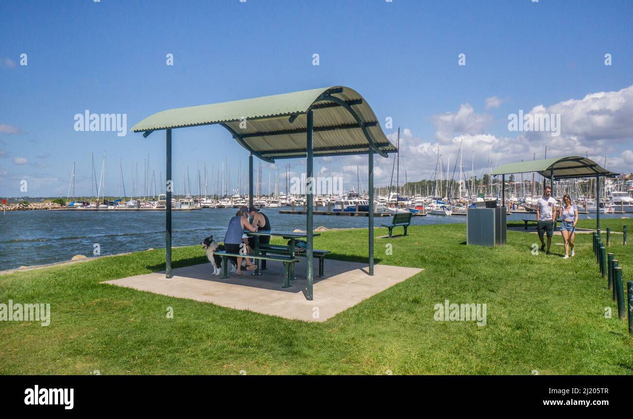 picnic area at Norfolk Point which forms the entrance to Manly Boat Harbour, named after Matthew Flinders sloop HMS Norfolk, Southern Moreton Bay, Man Stock Photo
