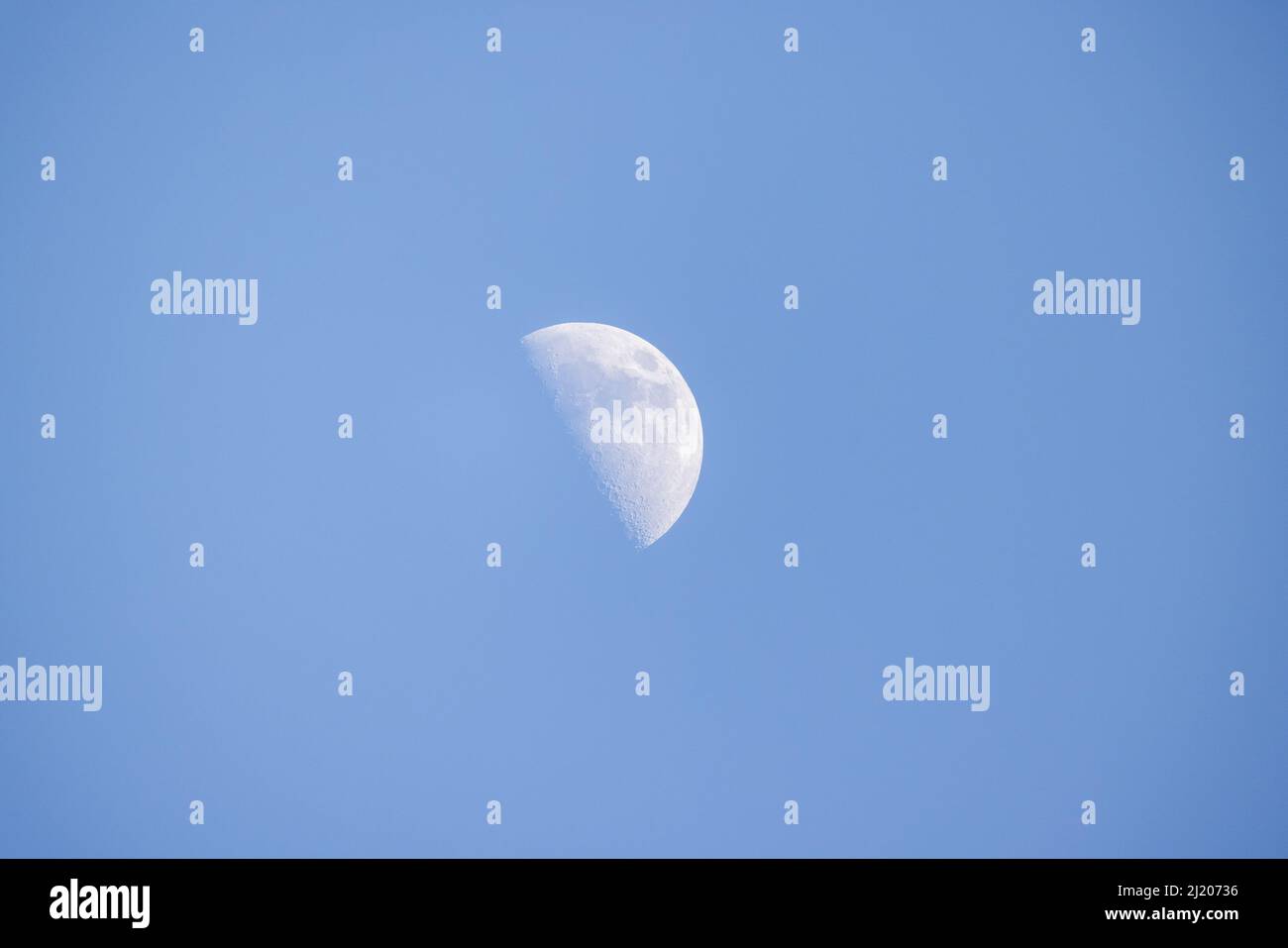 Half moon or waning moon with blue sky. The majestic moon, clear sky. High quality photo Stock Photo