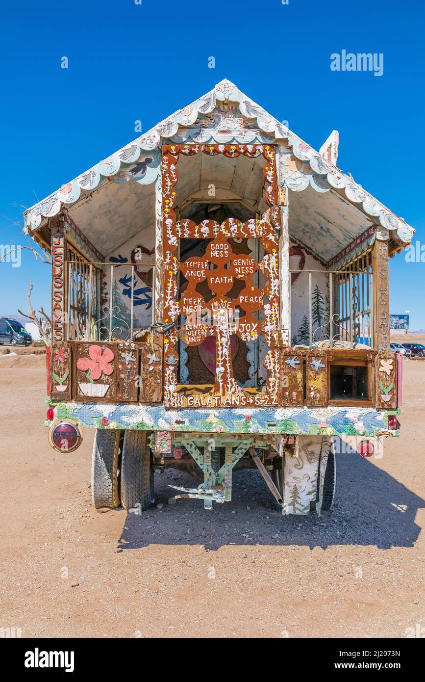 A Salvation Mountain truck decorated with religious sayings on the