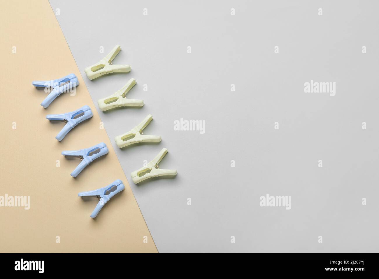 Plastic clothes pins on light background Stock Photo