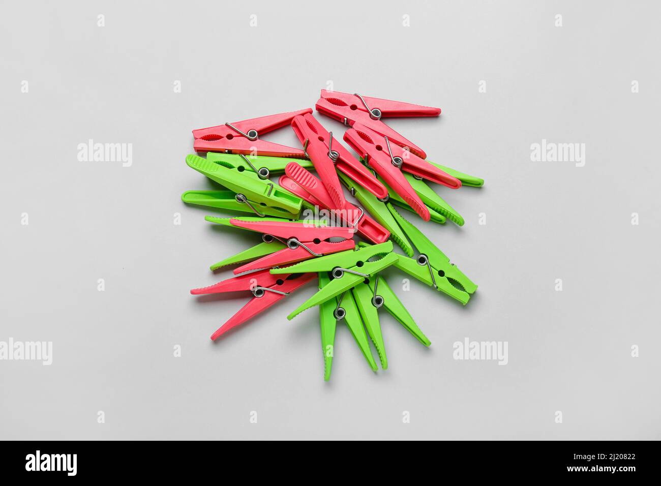 Plastic clothes pins on grey background Stock Photo