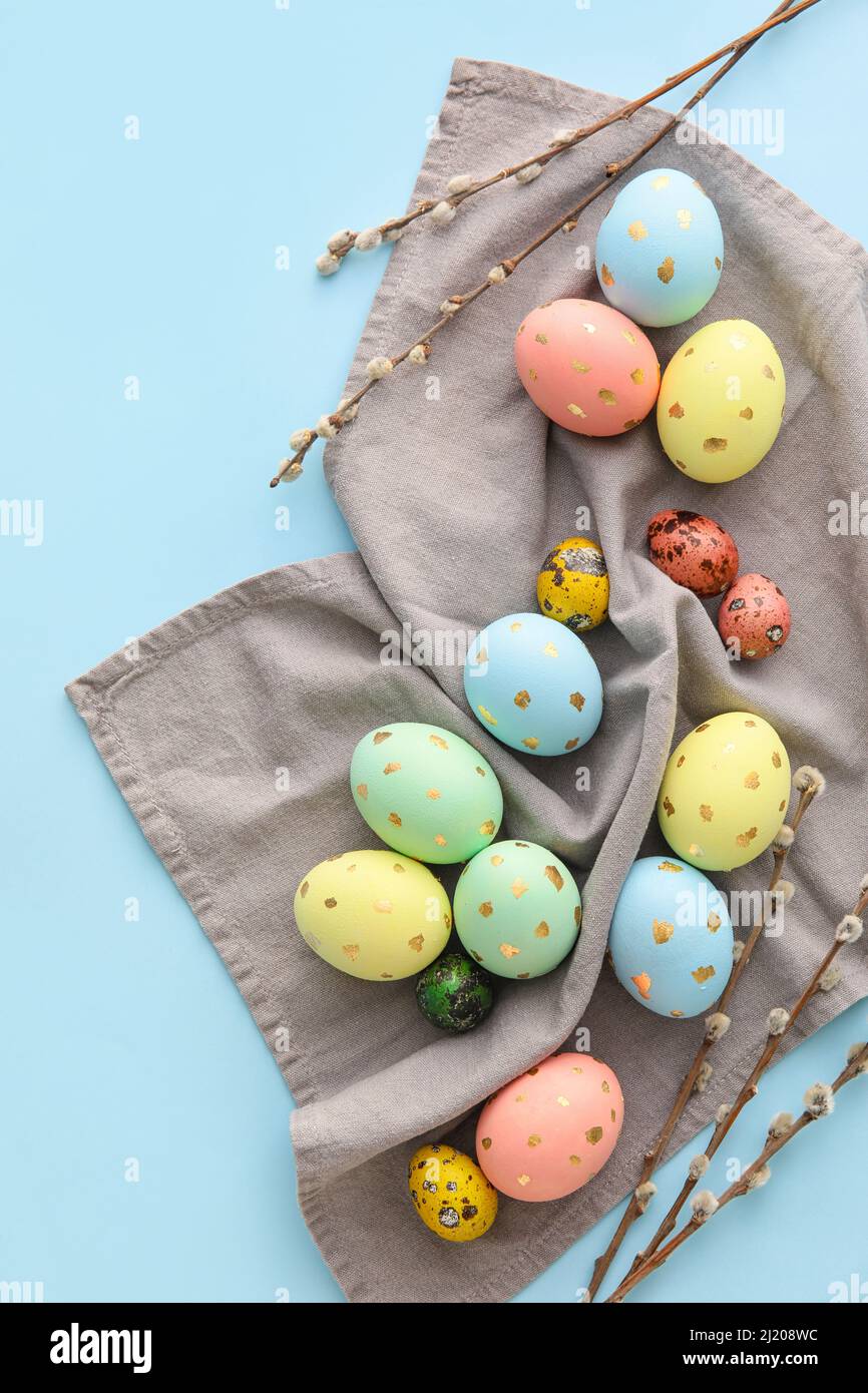 Painted Easter eggs and willow branches on blue background Stock Photo ...