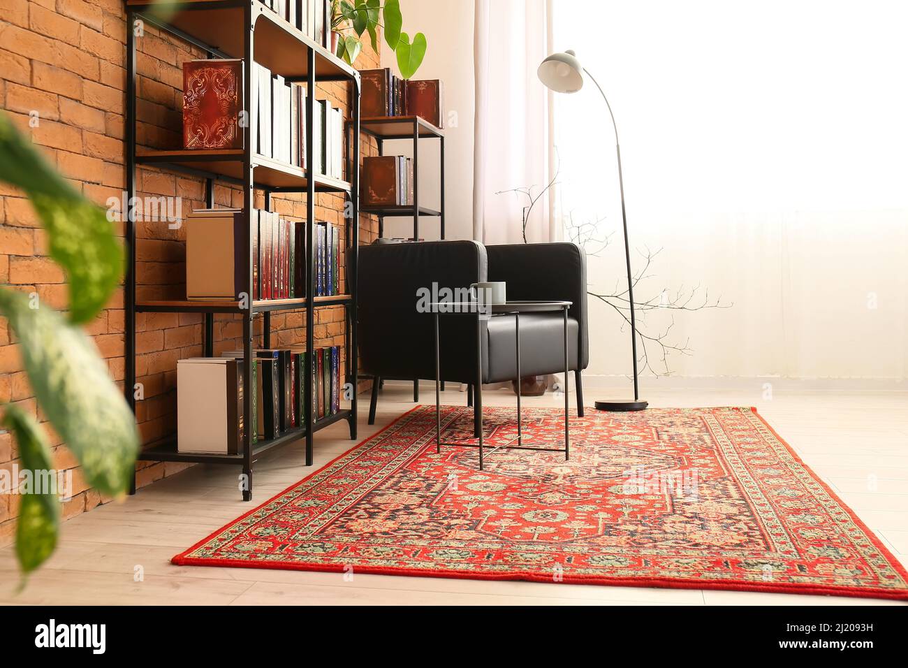 Interior of cozy living room with vintage carpet, armchair and
