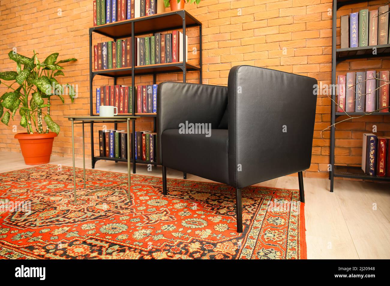 Interior of cozy living room with vintage carpet, armchair and